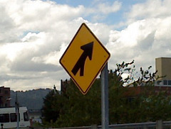 Identify the sign shown below  A. Right Lane Ends Sign  B. No U-Turns Sign  C. Merge Sign