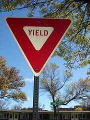 Identify the sign with shape below:  A. Railroad Crossing Sign  B. Yield Sign  C. Roadside Attraction Sign  D. Lane Change Sign