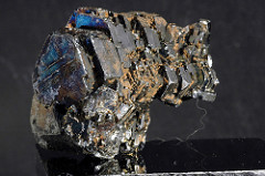 Hematite: Metallic; 5.5-6.5 hardness; no cleavage; dark metallic gray; light brown streak; slightly magnetic