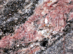 potassium feldspar: NM (glossy); 6.5 Hardness; Cubic Cleavage; light pink; no streak; light pink with lighter white part; Chemical Formula: KAlSi3O8